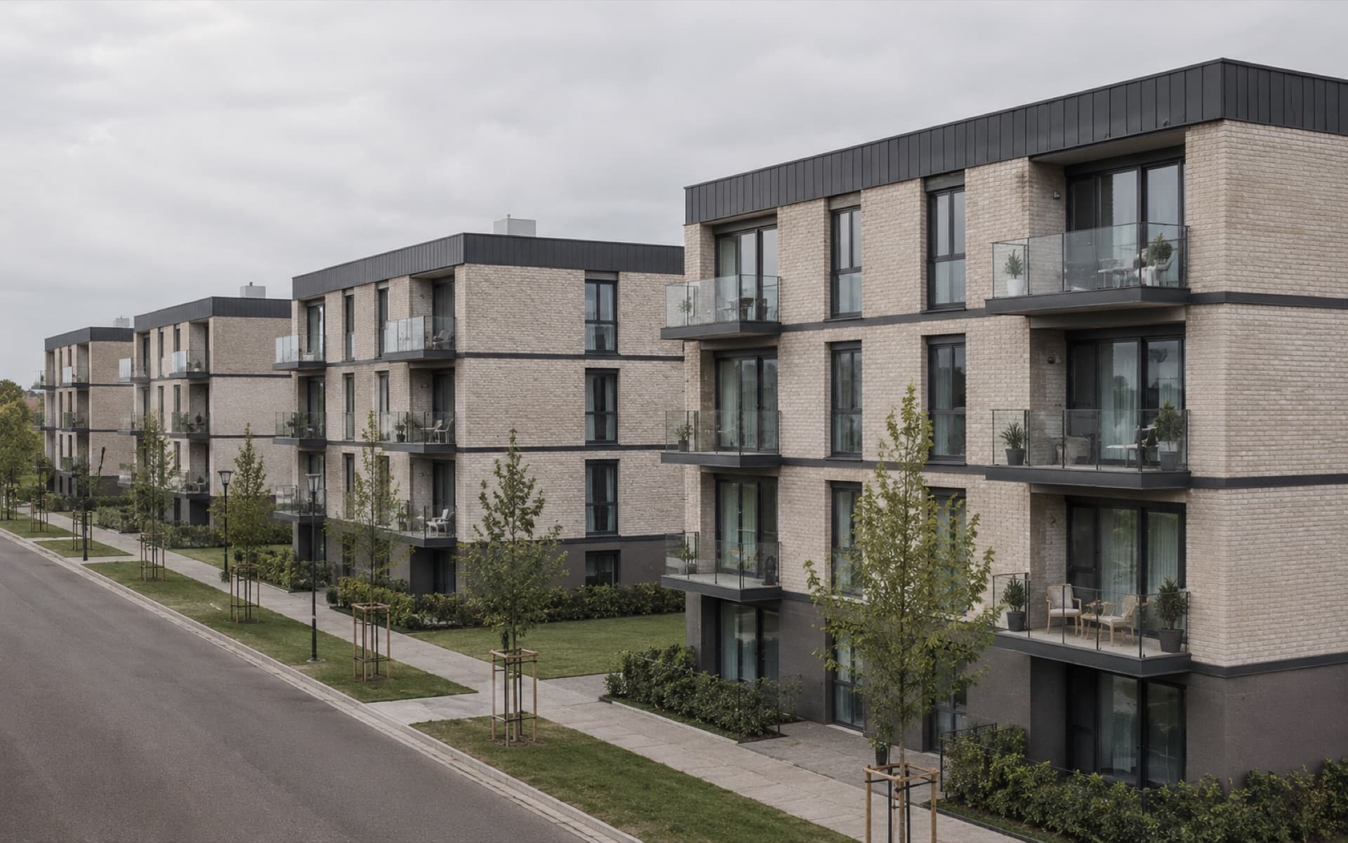 Gereihte Wohnblöcke mit Klinkerfassade und Glasbalkonen entlang einer Quartiersstraße — Visualisierung